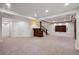 Finished basement features a wet bar, ample lighting, and a media center at 6687 S Forest Way # E, Centennial, CO 80121
