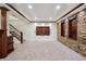 Finished basement with carpet, wood trim, a feature wall, and entertainment center at 6687 S Forest Way # E, Centennial, CO 80121