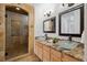 Stylish bathroom features a glass enclosed shower, dual sinks with vessel basins, and granite countertops at 6687 S Forest Way # E, Centennial, CO 80121