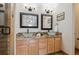 Bathroom with double sinks, granite countertops, modern fixtures, and tile flooring at 6687 S Forest Way # E, Centennial, CO 80121