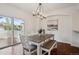Dining area with modern chandelier and sliding doors to the exterior at 6687 S Forest Way # E, Centennial, CO 80121