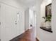 Bright entryway featuring hardwood floors, white walls, and decorative plant at 6687 S Forest Way # E, Centennial, CO 80121