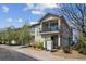 Inviting condo showcasing private balcony, desert landscaping, and attached garage at 6687 S Forest Way # E, Centennial, CO 80121