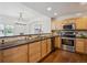 Well-lit kitchen offering wood cabinets, granite countertops, and stainless steel appliances at 6687 S Forest Way # E, Centennial, CO 80121