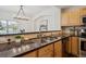 Kitchen area featuring granite countertops, tile backsplash, and stainless steel sink at 6687 S Forest Way # E, Centennial, CO 80121