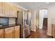 Kitchen boasts granite counters, stainless fridge, and hardwood floors at 6687 S Forest Way # E, Centennial, CO 80121