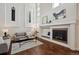 Bright living room with fireplace, tall ceilings, and modern decor at 6687 S Forest Way # E, Centennial, CO 80121
