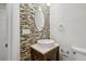 The powder room features designer tile and a pedestal sink at 6687 S Forest Way # E, Centennial, CO 80121