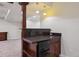 Basement wet bar has dark countertops, a sink, and a mini fridge at 6687 S Forest Way # E, Centennial, CO 80121