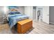 Bedroom featuring a blue bed set, a wooden chest, and wood-look flooring at 2995 Albion St, Denver, CO 80207