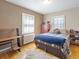 Bedroom featuring hardwood floors, neutral paint, and natural light from the window at 2995 Albion St, Denver, CO 80207