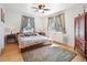 Bright bedroom featuring hardwood floors, neutral paint, a ceiling fan, and natural light from the windows at 2995 Albion St, Denver, CO 80207