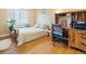 Cozy bedroom features hardwood floors and a built-in desk at 2995 Albion St, Denver, CO 80207