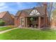 Charming brick home with a well-manicured lawn and a cozy covered porch perfect for relaxing at 2995 Albion St, Denver, CO 80207