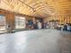 Spacious garage with exposed wood beams, ample storage space, and a connected doorway to the backyard at 2995 Albion St, Denver, CO 80207