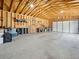 Spacious garage with exposed wood beams, ample storage space, and multiple garage doors at 2995 Albion St, Denver, CO 80207