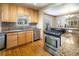 Well-lit kitchen showcasing stainless steel appliances, granite countertops, and hardwood flooring at 2995 Albion St, Denver, CO 80207