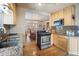 Well-lit kitchen showcasing stainless steel appliances, granite countertops, and hardwood flooring at 2995 Albion St, Denver, CO 80207