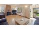 Spacious living room with hardwood floors, fireplace, and bright natural light from large windows at 2995 Albion St, Denver, CO 80207