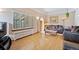 Bright living room with hardwood floors and neutral walls featuring large windows and comfortable seating at 2995 Albion St, Denver, CO 80207