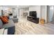 Open living room with gray walls, light vinyl flooring, and modern furnishings perfect for entertaining at 2995 Albion St, Denver, CO 80207