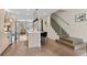 Modern kitchen with stainless steel appliances, island with bar seating, and hardwood floors at 3885 Vrain St, Denver, CO 80212
