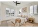 Bright bedroom featuring large windows, neutral decor, and a ceiling fan for a comfortable and relaxing atmosphere at 9081 Westminster Blvd, Westminster, CO 80031
