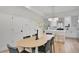 Elegant dining area next to a modern kitchen with stainless steel appliances and white cabinets at 9081 Westminster Blvd, Westminster, CO 80031