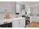 Modern kitchen featuring stainless steel appliances, white cabinets, and stylish backsplash at 9081 Westminster Blvd, Westminster, CO 80031