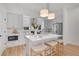 Bright kitchen with quartz countertops, stainless appliances, pendant lighting, and counter seating at 9081 Westminster Blvd, Westminster, CO 80031