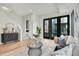 Inviting living room with black frame doors, contemporary furniture, and stylish decor, creating a cozy atmosphere at 9081 Westminster Blvd, Westminster, CO 80031