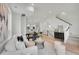 Open-concept living area with modern furnishings, light wood floors, and a staircase, blending style and functionality at 9081 Westminster Blvd, Westminster, CO 80031