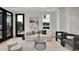 Bright living room with modern furniture, neutral tones, and access to balcony through black framed glass doors at 9081 Westminster Blvd, Westminster, CO 80031