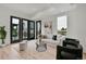 Contemporary living room with natural light, stylish decor, and seamless indoor-outdoor flow from glass doors to balcony at 9081 Westminster Blvd, Westminster, CO 80031
