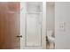 Bathroom featuring a shower with glass enclosure and a modern toilet for added convenience at 13950 E Oxford Pl # B105, Aurora, CO 80014