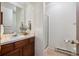 Bathroom featuring a vanity with updated fixture, and a shower with a glass door at 13950 E Oxford Pl # B105, Aurora, CO 80014