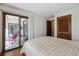 This light-filled bedroom features sliding door access to a balcony at 13950 E Oxford Pl # B105, Aurora, CO 80014