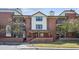 Inviting exterior view of the multi-story condo with brick accents and an outdoor porch at 13950 E Oxford Pl # B105, Aurora, CO 80014