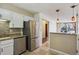 Kitchen with stainless steel appliances and granite counters conveniently located near dining area at 13950 E Oxford Pl # B105, Aurora, CO 80014