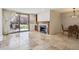 An open-concept living space boasting a fireplace, tile flooring, and a sliding glass door to a patio at 13950 E Oxford Pl # B105, Aurora, CO 80014