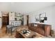 Bright living room featuring stylish furnishings and an open floor plan leading into the kitchen at 13950 E Oxford Pl # B105, Aurora, CO 80014