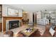 Inviting living room boasts a cozy fireplace, dining area, and breakfast bar with modern pendant lighting at 13950 E Oxford Pl # B105, Aurora, CO 80014