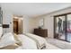 Bright main bedroom featuring neutral color palette, sliding glass door, and tiled floor at 13950 E Oxford Pl # B105, Aurora, CO 80014