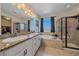 Luxurious bathroom featuring granite countertops, a soaking tub, and a glass shower at 42073 Colonial Trl, Elizabeth, CO 80107