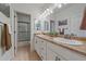 Bright bathroom with dual sinks, granite countertops, and a shower with glass door at 42073 Colonial Trl, Elizabeth, CO 80107