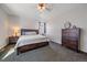 Comfortable bedroom with carpet, ceiling fan, natural light, and wood furnishings at 42073 Colonial Trl, Elizabeth, CO 80107