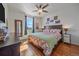 Comfortable bedroom with a ceiling fan, wood floors and dresser at 42073 Colonial Trl, Elizabeth, CO 80107