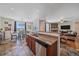 Spacious kitchen area open to the dining and living rooms with tile floors at 42073 Colonial Trl, Elizabeth, CO 80107