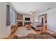 A warm living room with hardwood floors, comfy seating, a stone fireplace, and lots of natural light at 42073 Colonial Trl, Elizabeth, CO 80107