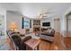 Inviting living room with a stone fireplace, hardwood floors, comfortable seating, and ample natural light at 42073 Colonial Trl, Elizabeth, CO 80107